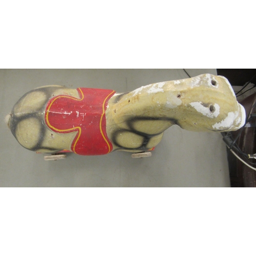 312 - A vintage painted pull-along toy dappled horse, on wheels  18