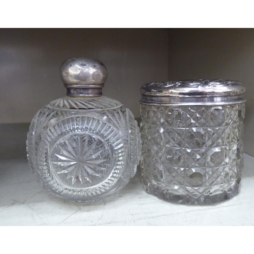 322 - Four dissimilar silver mounted dressing table jars  mixed marks