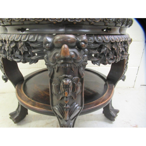 330 - A late 19thC Chinese, profusely carved rosewood side table with an inset, rust coloured marble surfa... 