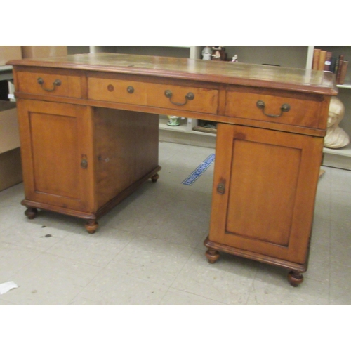 340 - A mid Victorian mahogany, twin pedestal desk, the top set with a tooled and gilded green hide scribe... 