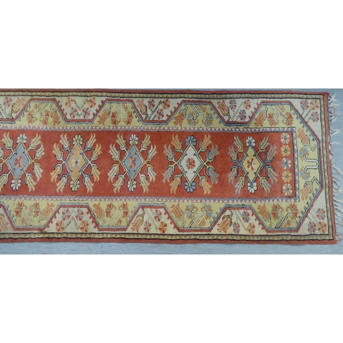 342 - A Turkish woollen runner, decorated in colours with repeating stylised designs  105