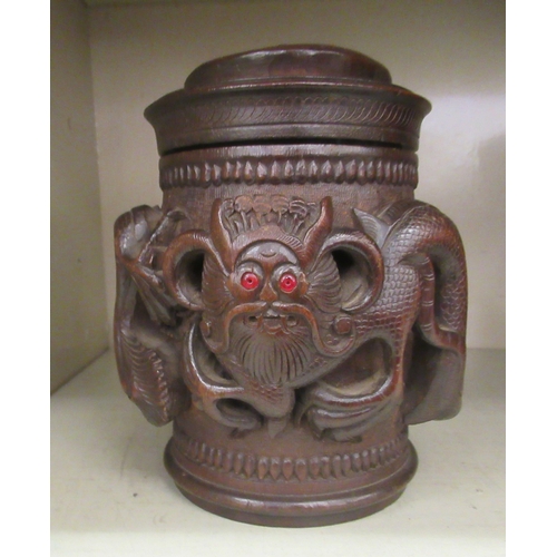 343 - An Oriental carved wooden tobacco jar and cover, decorated with dragons  7