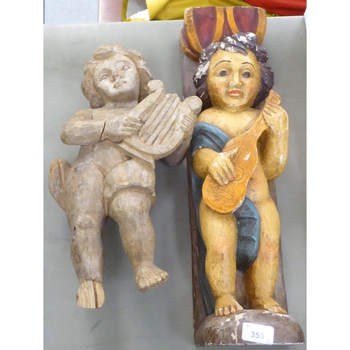 353 - Two dissimilar carved wooden cherubic figures, on plinths  21