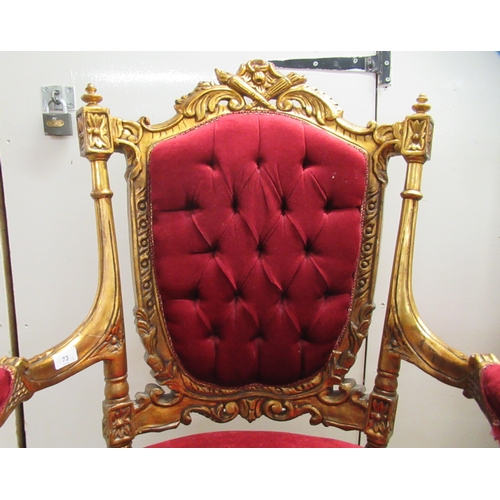 360 - A pair of late Victorian style gilded, moulded and carved salon chairs with open arms and part butto... 