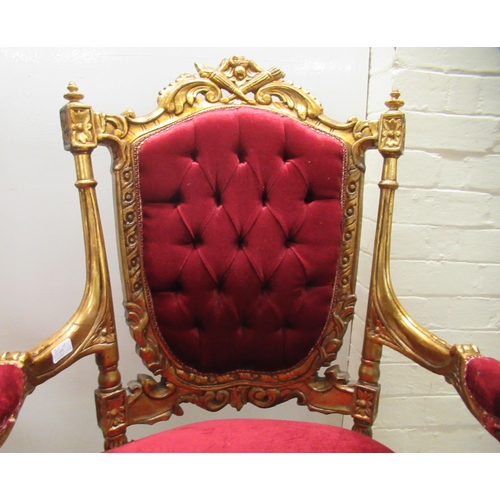 360 - A pair of late Victorian style gilded, moulded and carved salon chairs with open arms and part butto... 