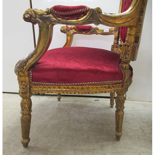 360 - A pair of late Victorian style gilded, moulded and carved salon chairs with open arms and part butto... 