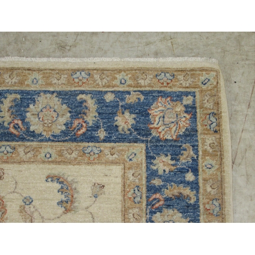 371 - A Persian Mahal rug, decorated with stylised flora and foliage, on a cream coloured ground with a bl... 