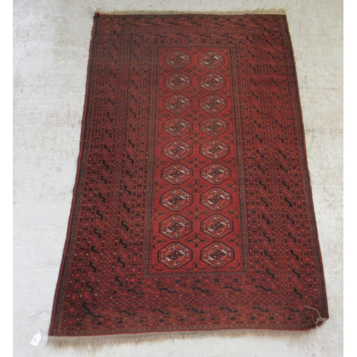 376 - A Bokhara rug, decorated with two columns of nine octagonal guls, on a red ground  41