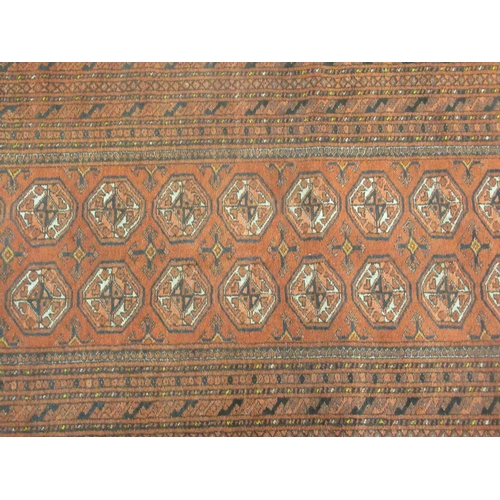 376 - A Bokhara rug, decorated with two columns of nine octagonal guls, on a red ground  41