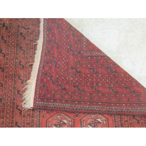 376 - A Bokhara rug, decorated with two columns of nine octagonal guls, on a red ground  41