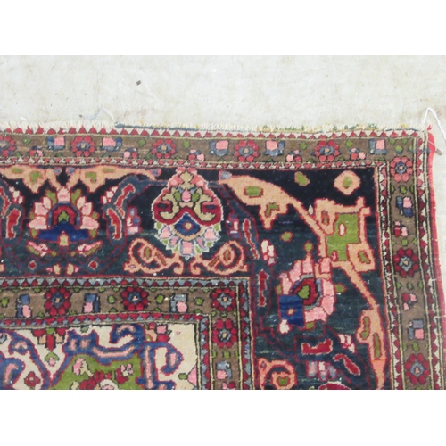 381 - An Isfahan rug, profusely decorated with repeating stylised designs, on a multi-coloured ground ... 