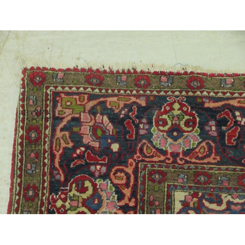 381 - An Isfahan rug, profusely decorated with repeating stylised designs, on a multi-coloured ground ... 