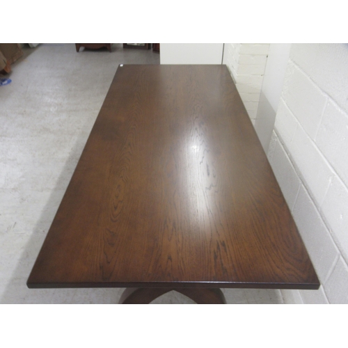 383 - A Stuart Linford stained oak dining table, the solid top raised on a pair of cross frame legs, unite... 