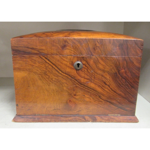 384 - A late Victorian walnut veneered needlework box of casket form with straight sides, a hinged lid, fa... 