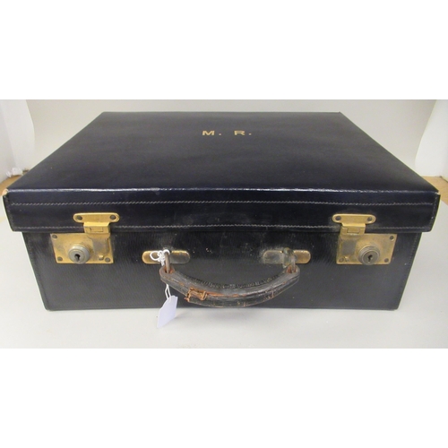 385 - An early 20thC Drew & Sons, Piccadilly Circus, London W, navy blue hide covered vanity case with... 