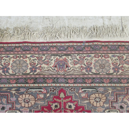 386 - An Usak rug, decorated with a central serpentine outlined motif, bordered by floral and other stylis... 