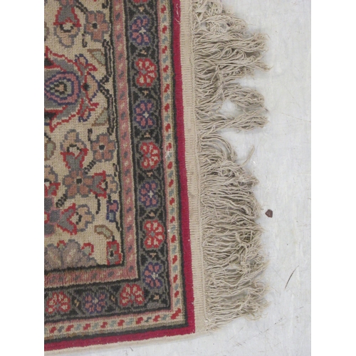 386 - An Usak rug, decorated with a central serpentine outlined motif, bordered by floral and other stylis... 