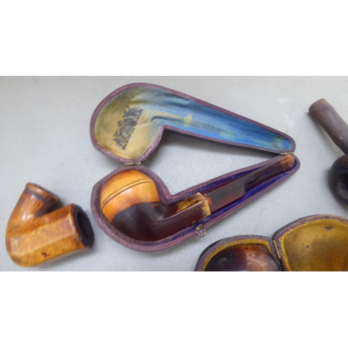 397 - Smoker's pipes: to include a Meersham example with an amber mouthpiece