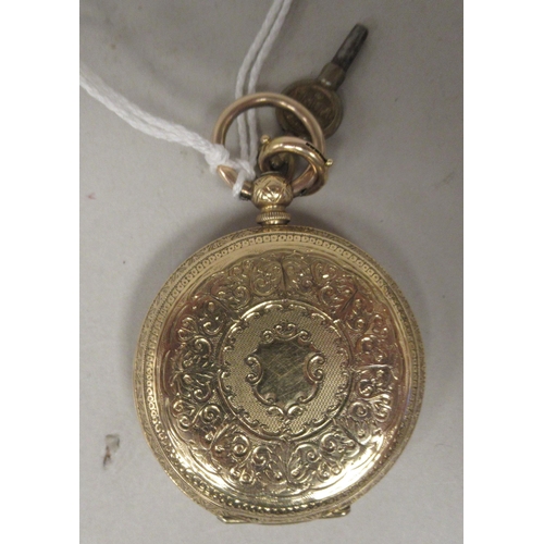 41 - An 18ct gold cased pocket watch with bright-cut engraved ornament, faced by an engine turned and flo... 