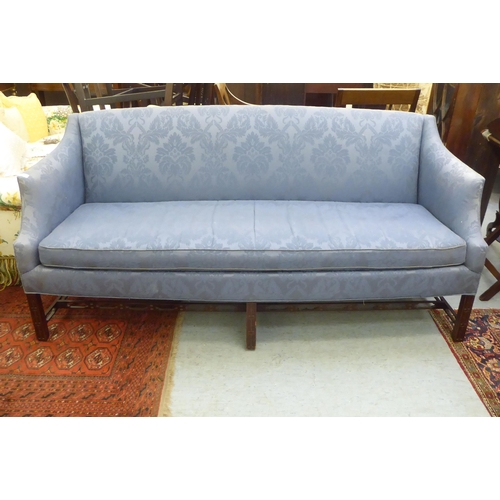 417 - A (possibly) American blue patterned fabric covered three person settee, raised on square mahogany l... 