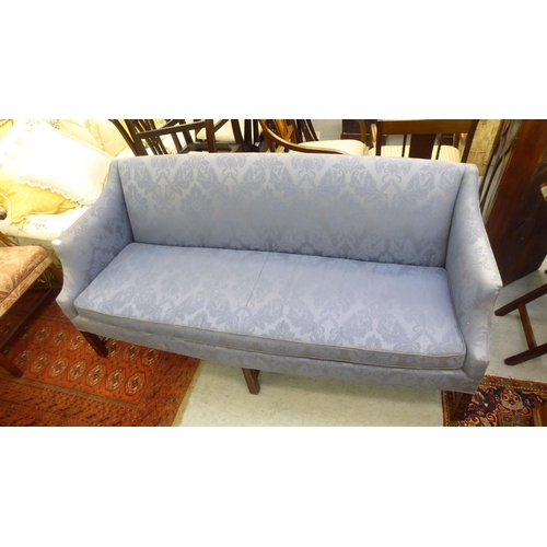 417 - A (possibly) American blue patterned fabric covered three person settee, raised on square mahogany l... 