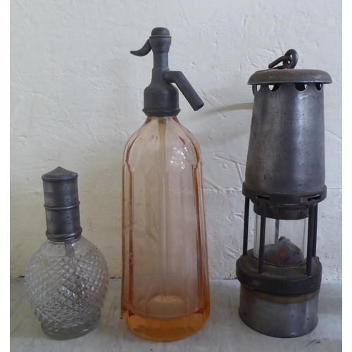 53 - Objects of purpose and desire: to include The Wolf Safety Lamp Co miners lamp; two sparklet glass so... 