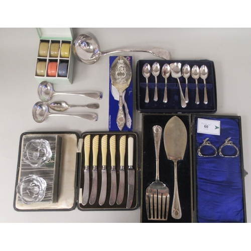 60 - A mixed lot: to include a pair of silver plated sauce ladles and a vintage set of six multi-coloured... 