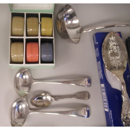 60 - A mixed lot: to include a pair of silver plated sauce ladles and a vintage set of six multi-coloured... 