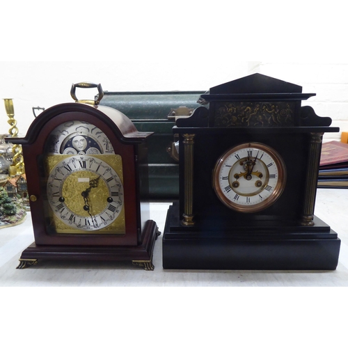 62 - A late Victorian black slate cased architectural style mantel clock; the bell strike movement with a... 