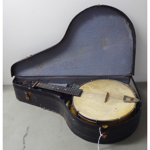 67 - A vintage four string ukulele banjo, in a carrying case 