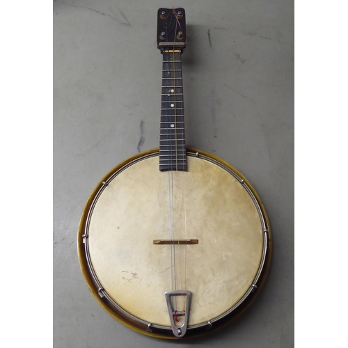 67 - A vintage four string ukulele banjo, in a carrying case 