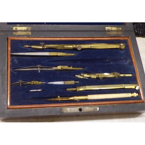 87 - A mixed lot: to include an early 20thC rosewood cased part set of engineering drawing instruments