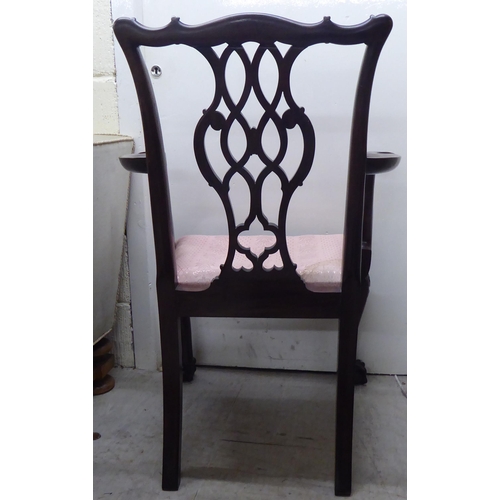 91 - A 1930s mahogany showwood framed Chippendale design pierced and carved splat back open arm chair, th... 