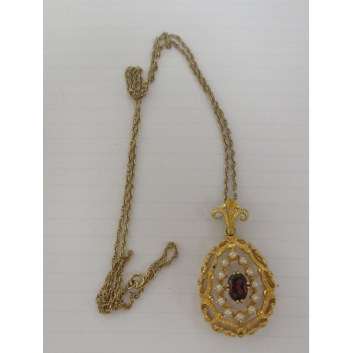 347 - A 9ct textured gold peardrop shaped pendant, set with a coloured stone and seed pearls, on a fine ye... 