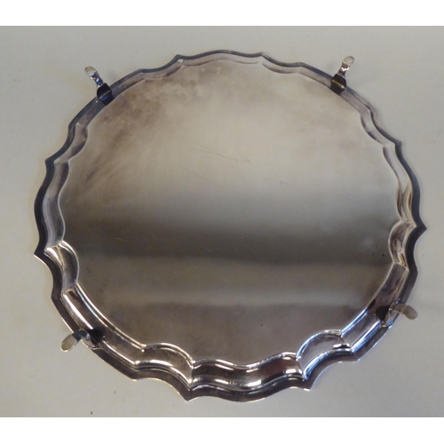 1 - A Georgian style silver salver with a raised piecrust border, on pad feet  Peyton, Pepper & Sons... 