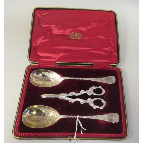 10 - A pair of late Victorian silver plated fruit spoons with decoratively scroll engraved ornament; and ... 