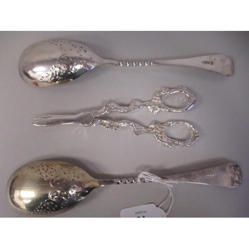 10 - A pair of late Victorian silver plated fruit spoons with decoratively scroll engraved ornament; and ... 