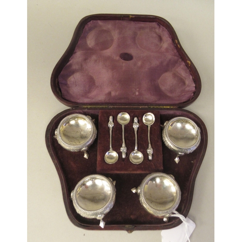 112 - A set of four mid Victorian silver salt cellars of squat, bulbous form with floral engraved and chas... 