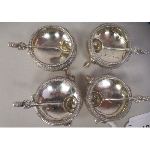 112 - A set of four mid Victorian silver salt cellars of squat, bulbous form with floral engraved and chas... 