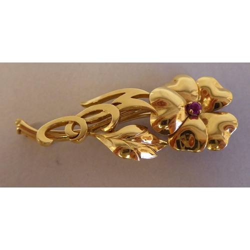 116 - An 18ct gold single stone ruby set floral brooch 