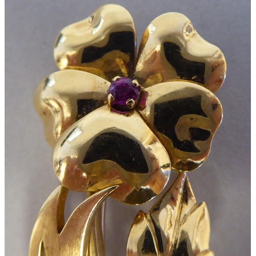 116 - An 18ct gold single stone ruby set floral brooch 