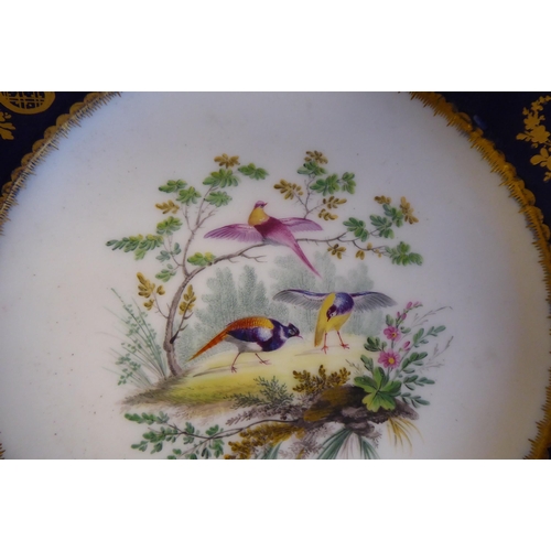 12 - Three similar 19thC Serves porcelain plates, decorated to the centres and border vignettes with stud... 