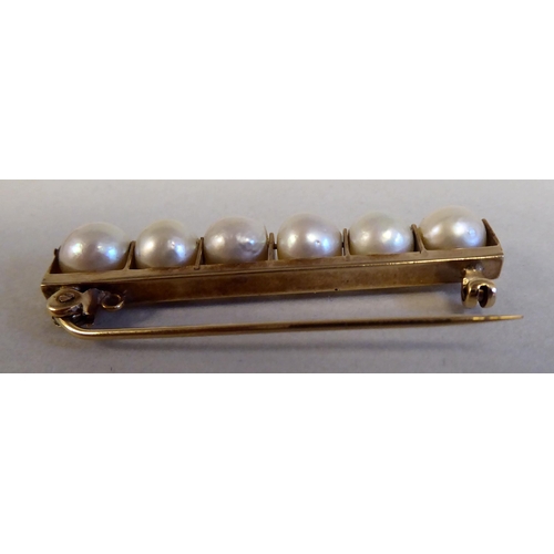 126 - A gold coloured metal bar brooch, set with six inline pearls; and a pair of twin bead pearl drop cli... 