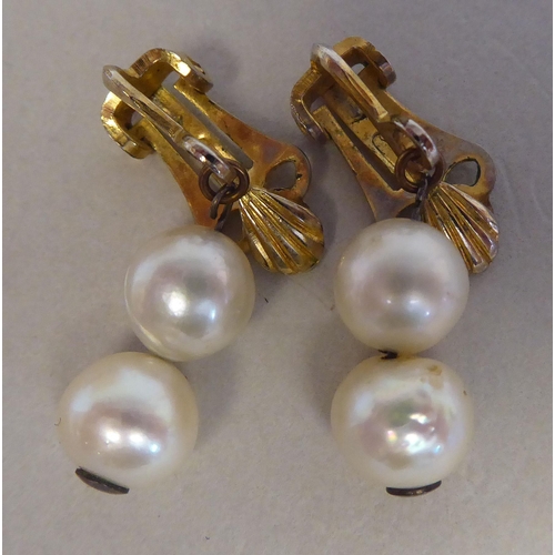 126 - A gold coloured metal bar brooch, set with six inline pearls; and a pair of twin bead pearl drop cli... 