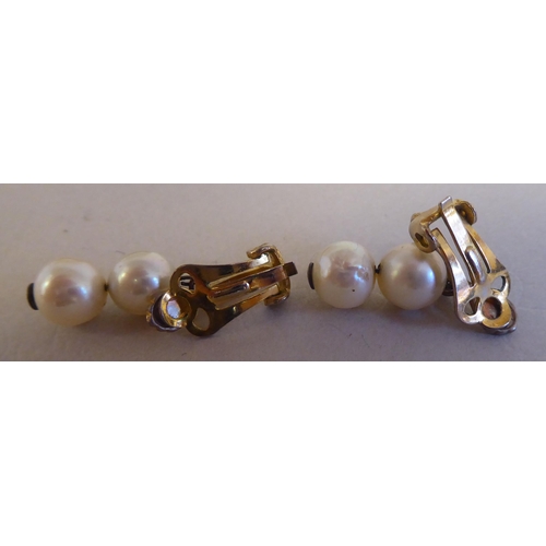 126 - A gold coloured metal bar brooch, set with six inline pearls; and a pair of twin bead pearl drop cli... 