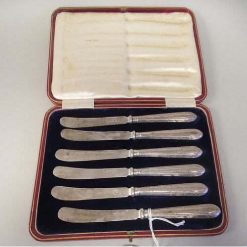 13 - A set of six tea knives, on bead bordered silver handles  Thomas Bradbury & Sons  Sheffield 1896... 