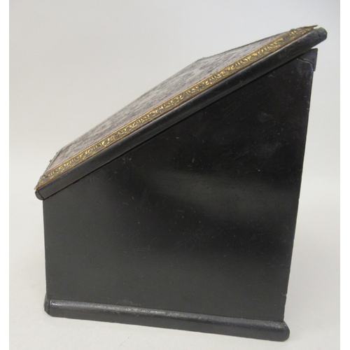 133 - A late 19thC black lacquered, boulleworked casket of trapezium form, the angled, lockable hinged lid... 