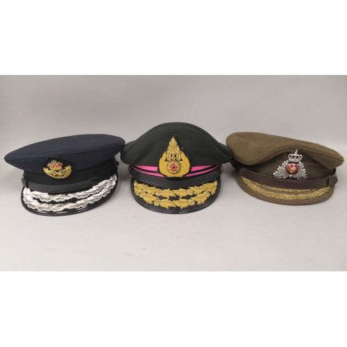 148 - Nine various unidentified foreign military officers' peaked uniform hats, decorated with emblems and... 