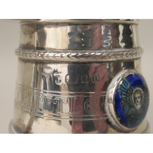 155 - A silver Christening pedestal mug of tapered cylindrical form with an angular handle, an applied cas... 