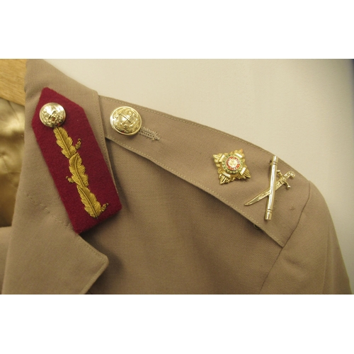 164 - A British Army General's khaki jacket and trousers with buttons, cross swords and baton emblems and ... 